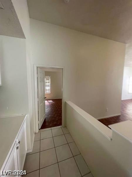 hall featuring light tile patterned floors