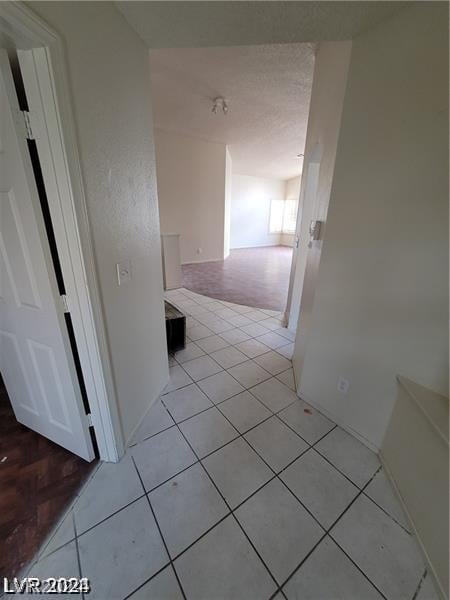 hall with light tile patterned floors