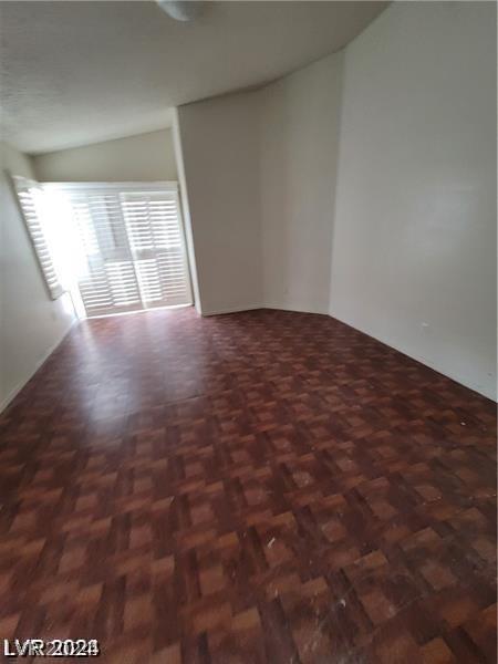 unfurnished room with dark parquet floors