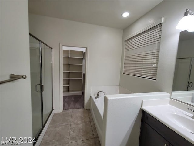 bathroom with tile patterned floors, vanity, and independent shower and bath