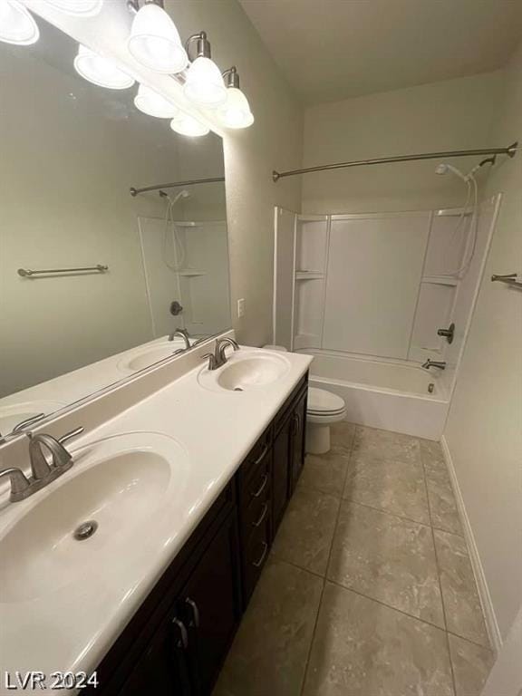 full bathroom with washtub / shower combination, tile patterned floors, vanity, and toilet