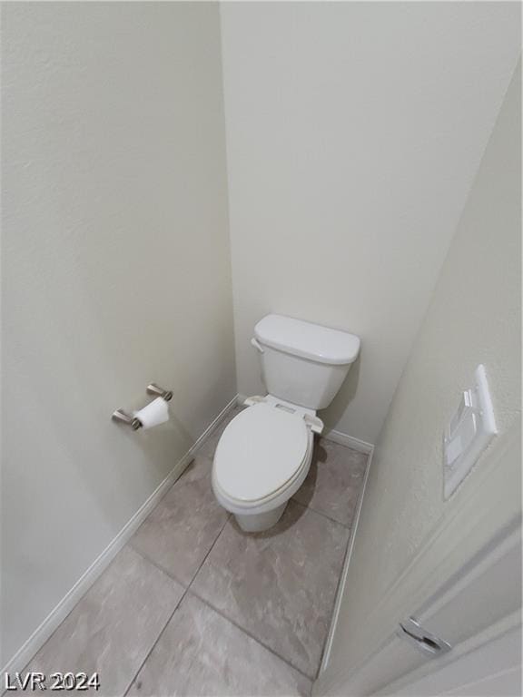 bathroom featuring tile patterned floors and toilet