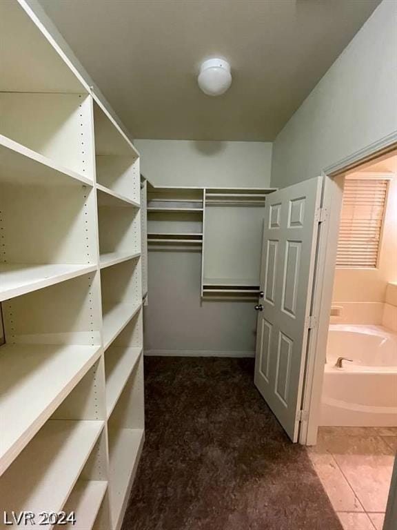 walk in closet with tile patterned floors