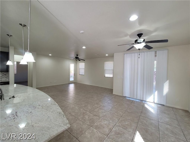 tiled spare room with ceiling fan