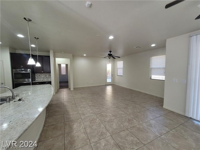 interior space featuring ceiling fan and sink