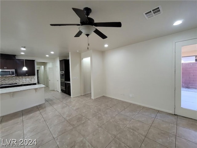 unfurnished living room featuring ceiling fan and light tile patterned flooring