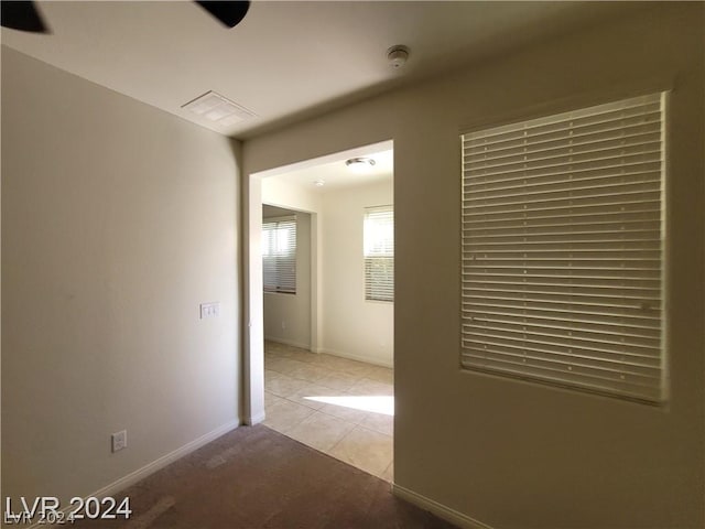 hall with light tile patterned floors