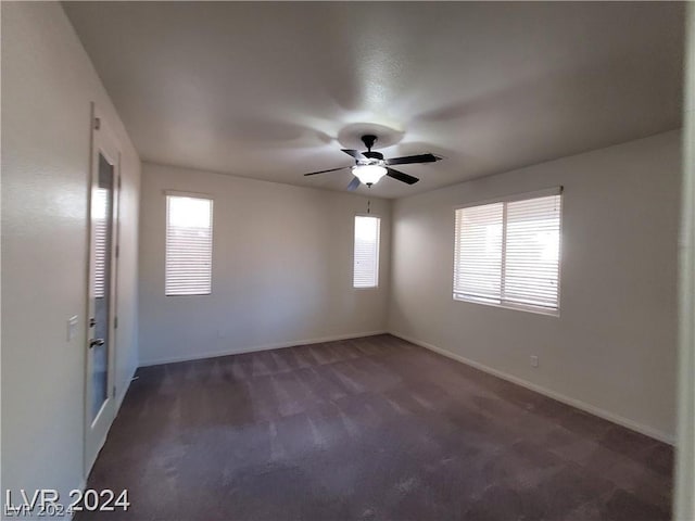 carpeted empty room featuring ceiling fan