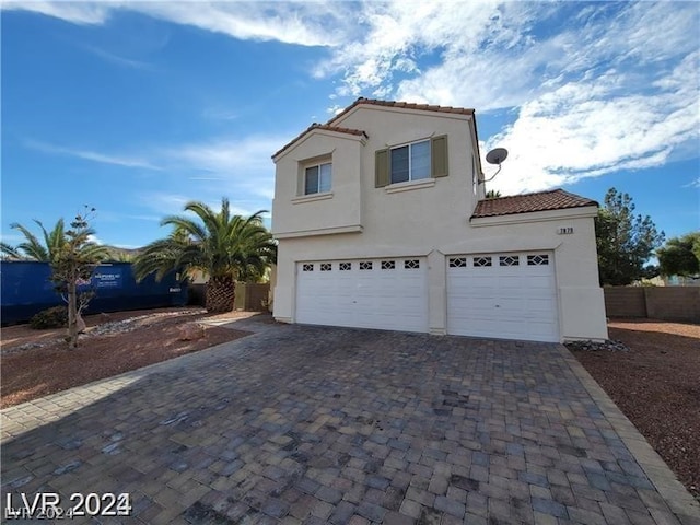 mediterranean / spanish house with a garage