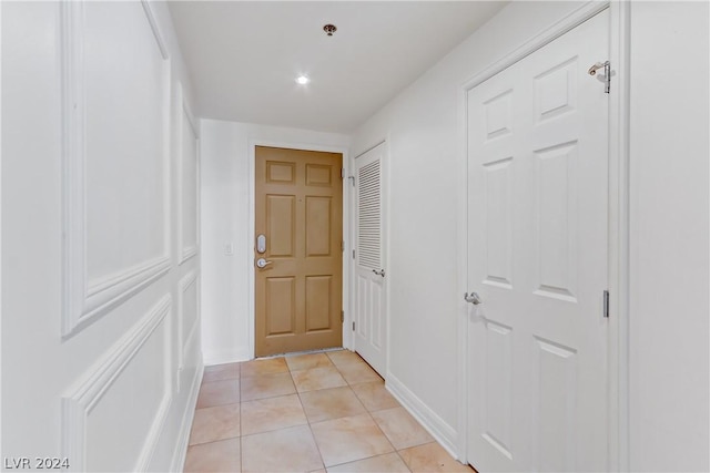 corridor featuring light tile patterned floors