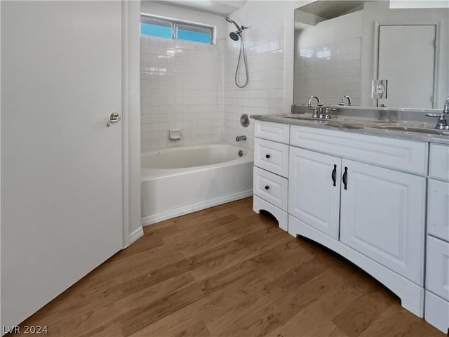 bathroom featuring vanity, hardwood / wood-style flooring, and tiled shower / bath