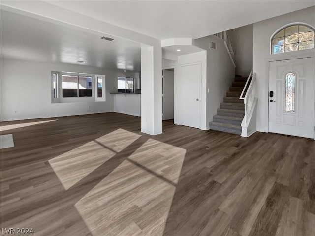 foyer with a healthy amount of sunlight and dark wood-type flooring