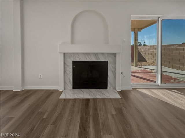 unfurnished living room featuring hardwood / wood-style flooring and a fireplace