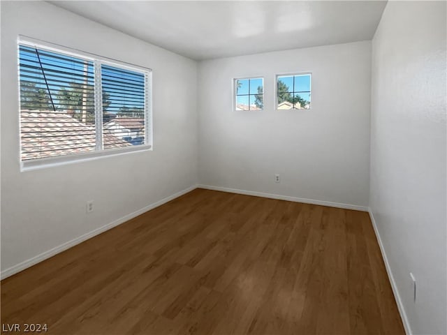 unfurnished room featuring dark hardwood / wood-style floors