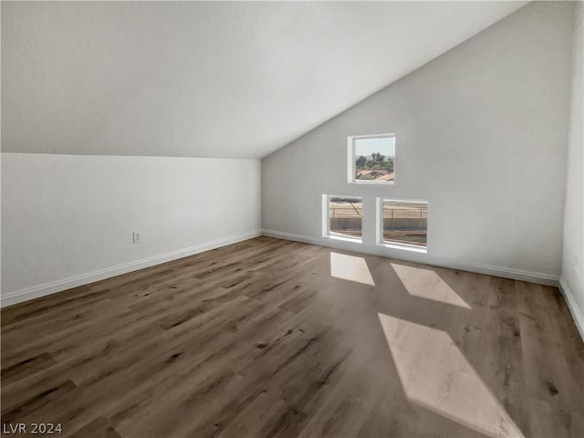 bonus room featuring dark hardwood / wood-style flooring and vaulted ceiling