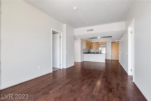 unfurnished living room featuring dark wood-type flooring