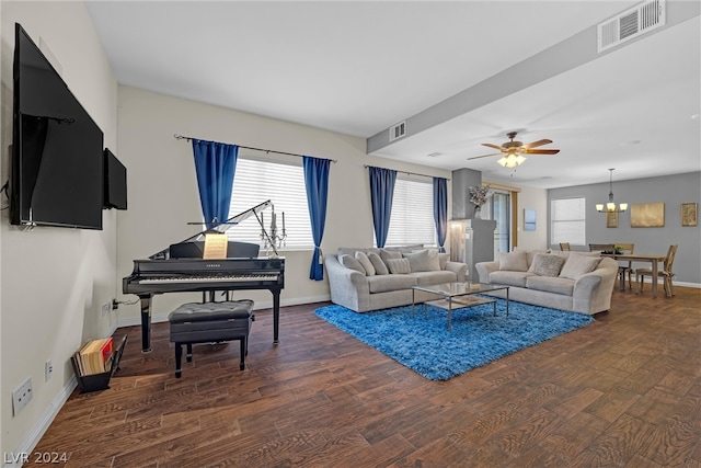 living room featuring dark wood-type flooring and ceiling fan with notable chandelier