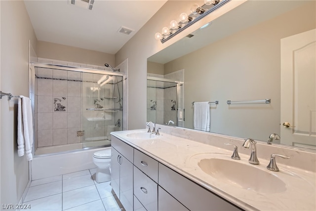 full bathroom featuring toilet, vanity, tile patterned flooring, and shower / bath combination with glass door