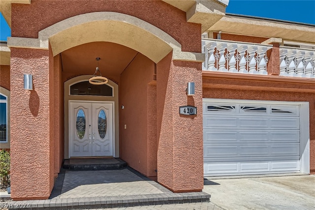 view of exterior entry with a balcony