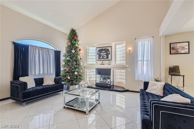 tiled living room featuring high vaulted ceiling