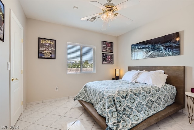 tiled bedroom featuring ceiling fan