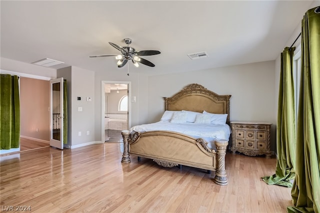 bedroom with ensuite bathroom, ceiling fan, and light hardwood / wood-style flooring