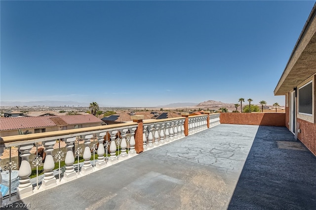 view of patio with a mountain view and a balcony