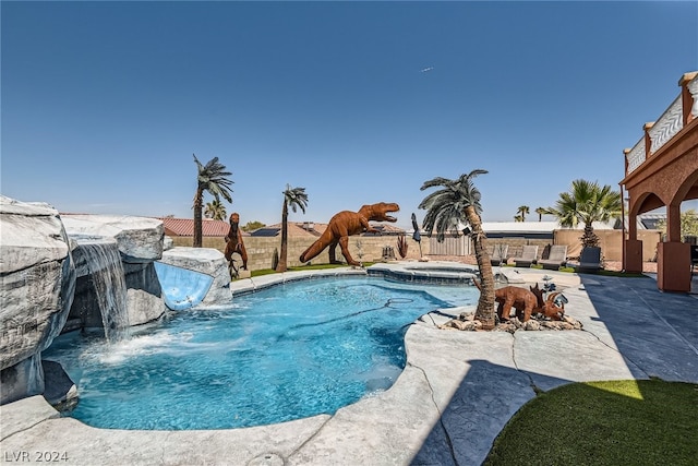 view of pool with a patio, an in ground hot tub, and pool water feature