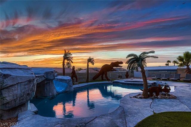 view of pool at dusk