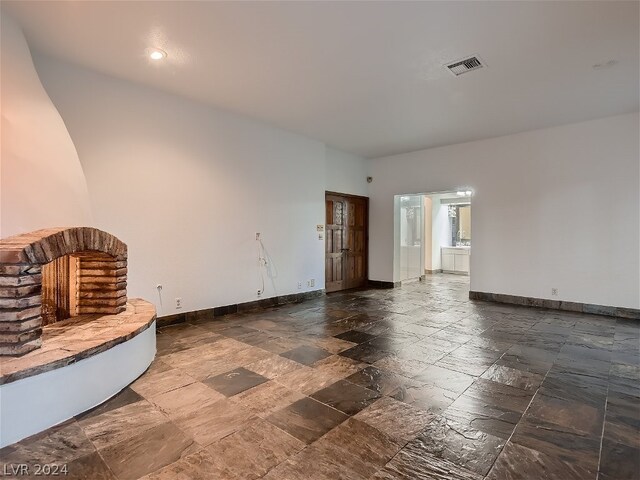 unfurnished living room featuring tile flooring