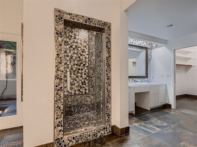 interior space featuring walk in shower, vanity, and tile floors