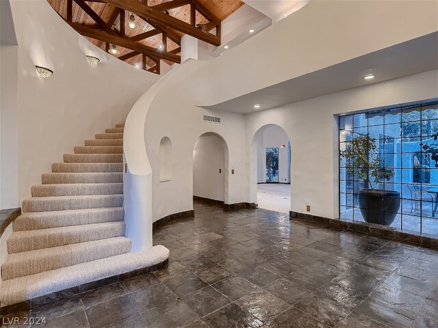 tiled foyer featuring a high ceiling