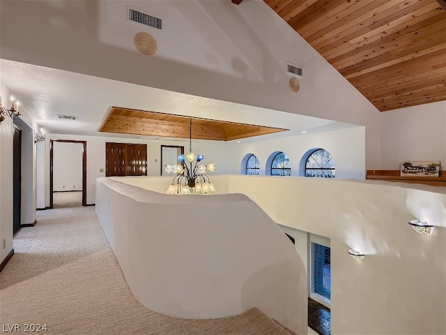 corridor with light carpet, wooden ceiling, vaulted ceiling, and an inviting chandelier