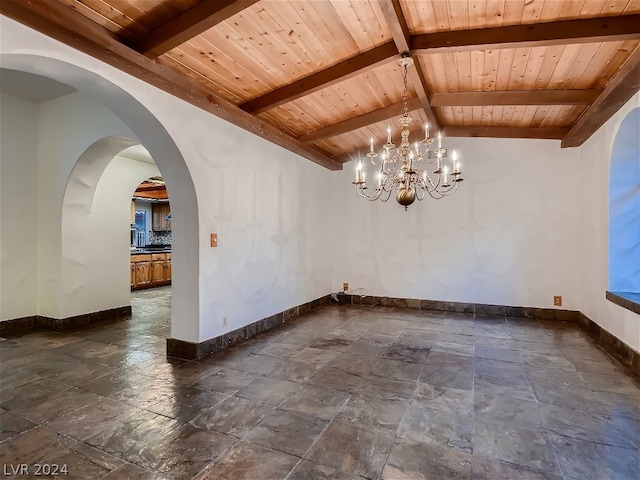 empty room featuring wood ceiling, a chandelier, dark tile flooring, and vaulted ceiling with beams