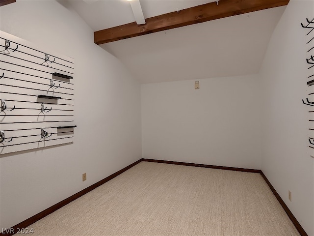 unfurnished room featuring light carpet, lofted ceiling with beams, and baseboards