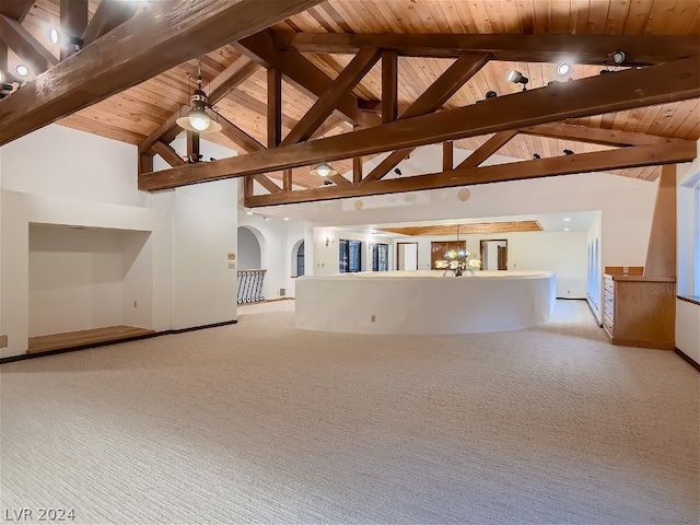 unfurnished living room featuring baseboards, beam ceiling, arched walkways, wood ceiling, and light colored carpet