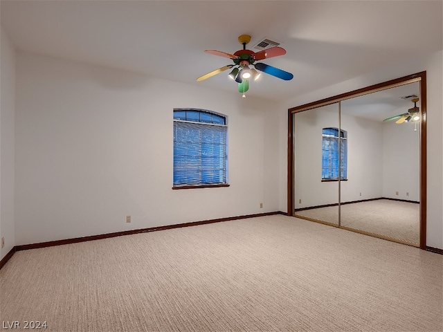 unfurnished bedroom with a closet, ceiling fan, baseboards, and carpet