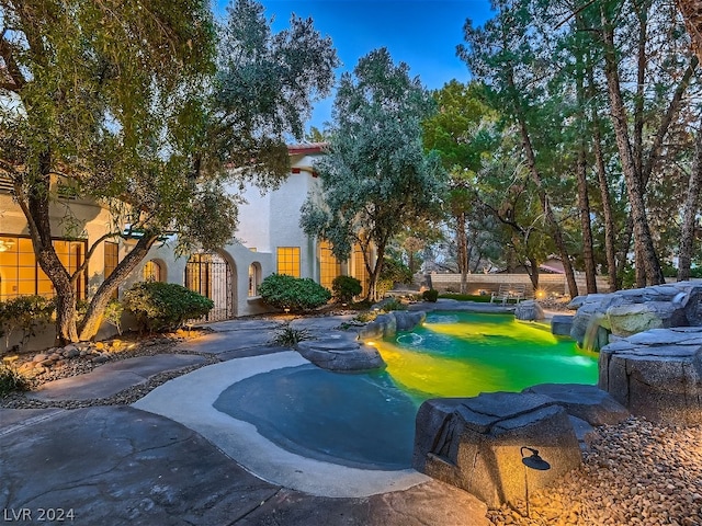 view of home's community featuring a pool, a gate, and fence