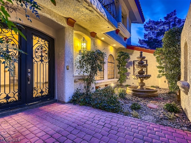 property entrance with stucco siding