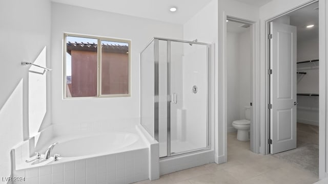 bathroom featuring tile patterned flooring, separate shower and tub, and toilet