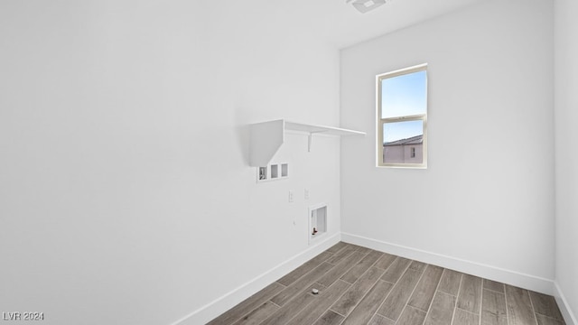 washroom with hookup for a washing machine and hardwood / wood-style flooring