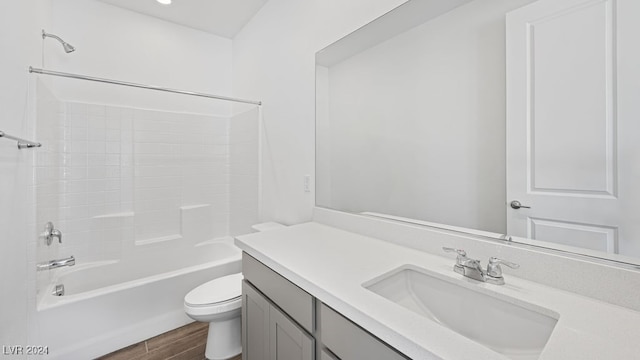 full bathroom featuring vanity, hardwood / wood-style floors, bathtub / shower combination, and toilet