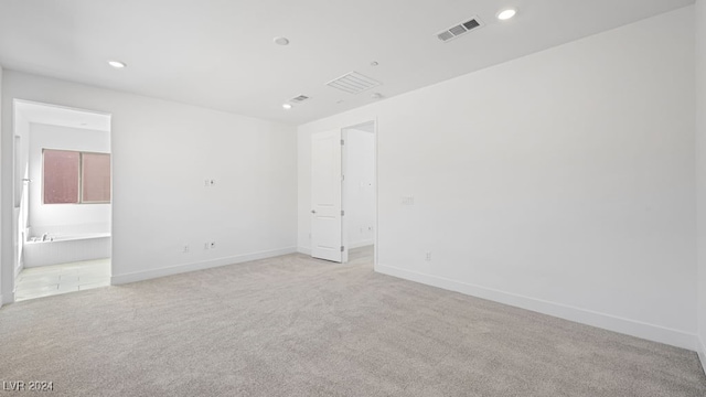 empty room featuring light carpet