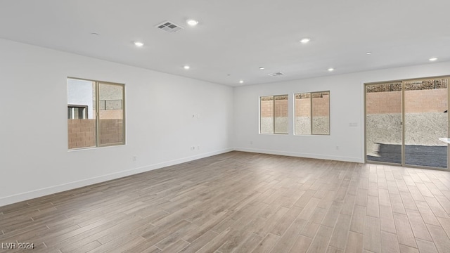 empty room with light hardwood / wood-style flooring