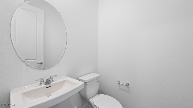 bathroom featuring sink and toilet