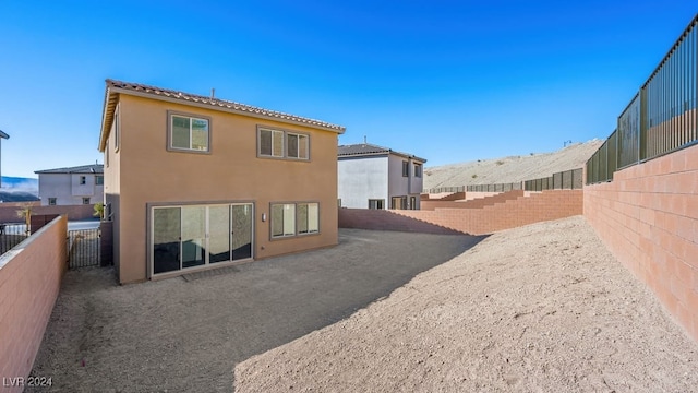 rear view of property featuring a patio area