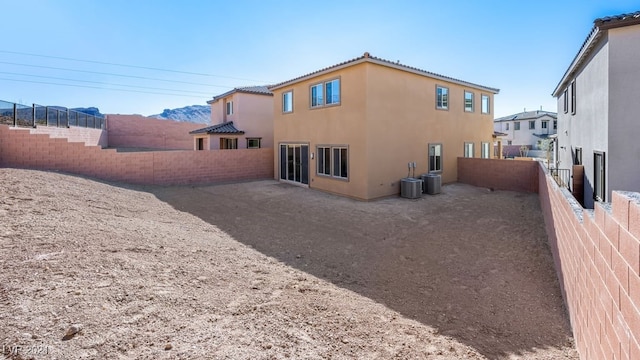 rear view of house featuring a mountain view and cooling unit