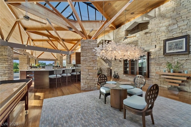 dining room with high vaulted ceiling, hardwood / wood-style flooring, wooden ceiling, and beamed ceiling