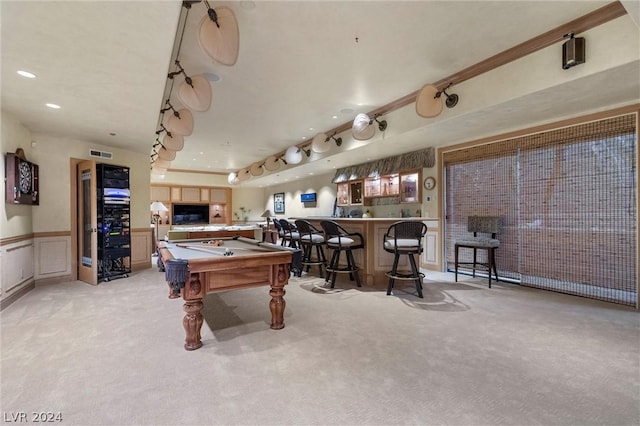 game room with pool table, bar, and light carpet