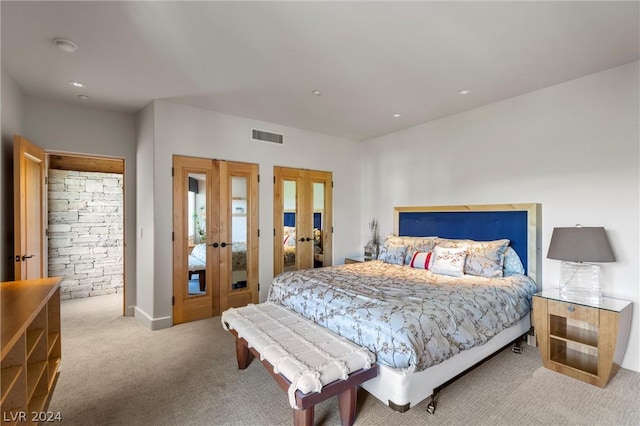 bedroom with light colored carpet and french doors